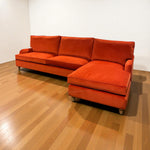 Load image into Gallery viewer, Orange sectional sofa on a wooden floor with white walls
