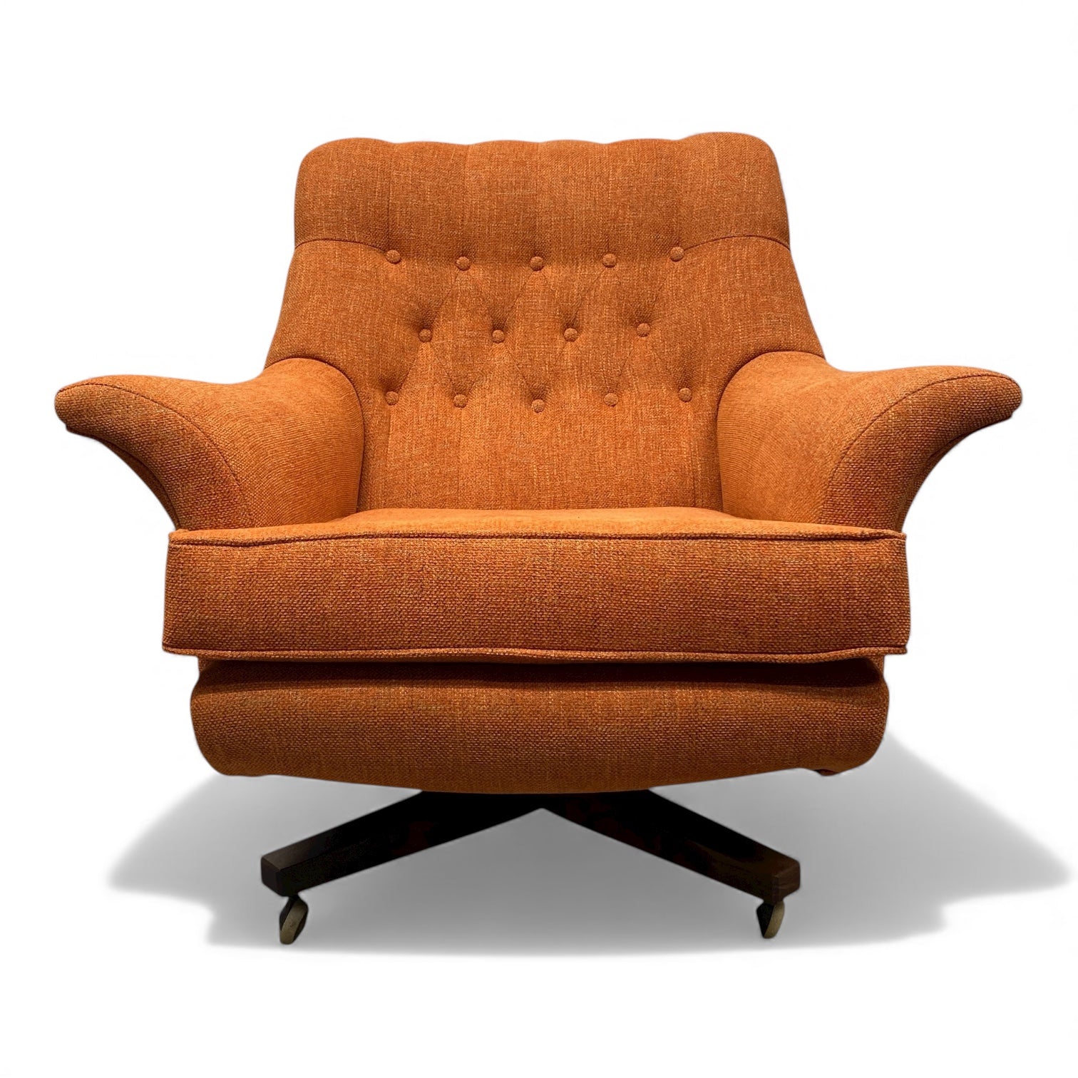 Orange armchair with a tufted backrest on a white background