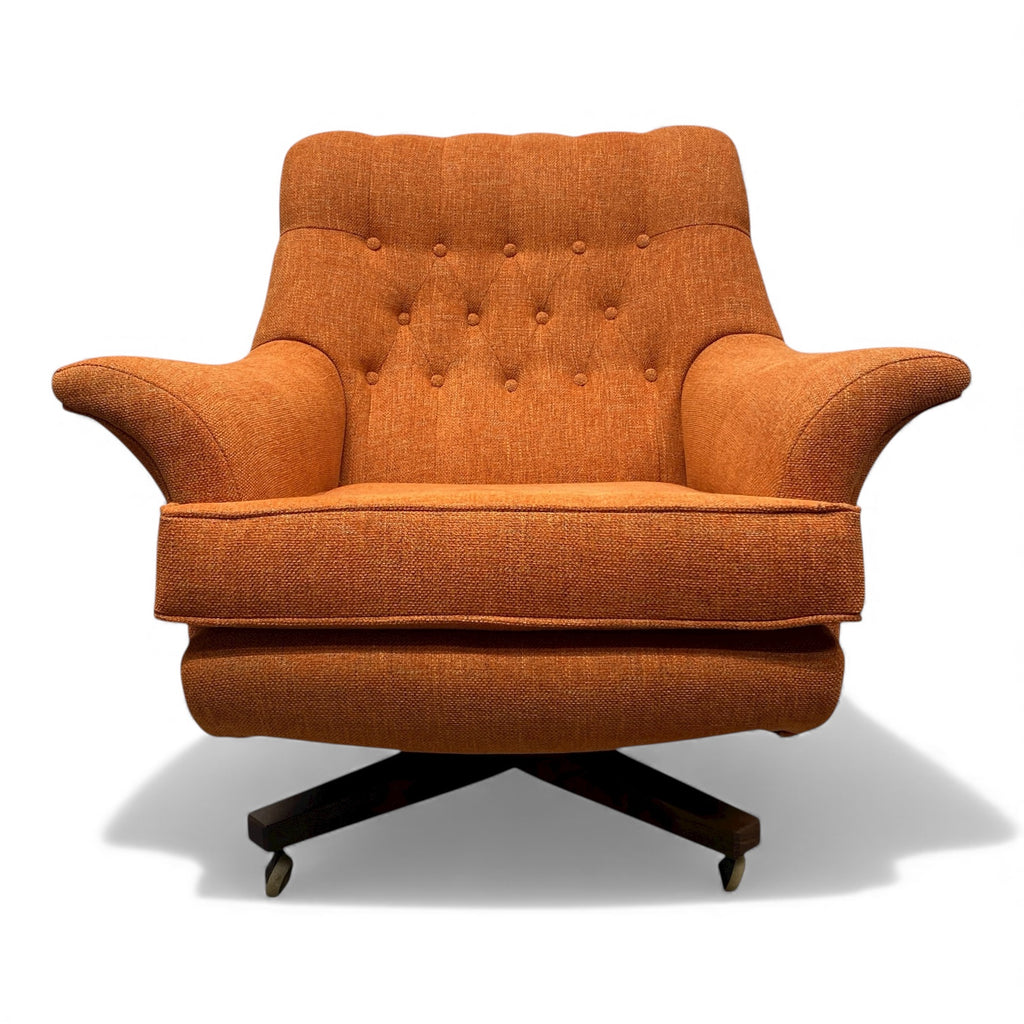 Orange armchair with a tufted backrest on a white background