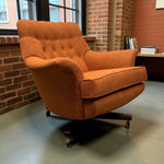 Load image into Gallery viewer, Orange armchair in a room with brick walls and a desk.

