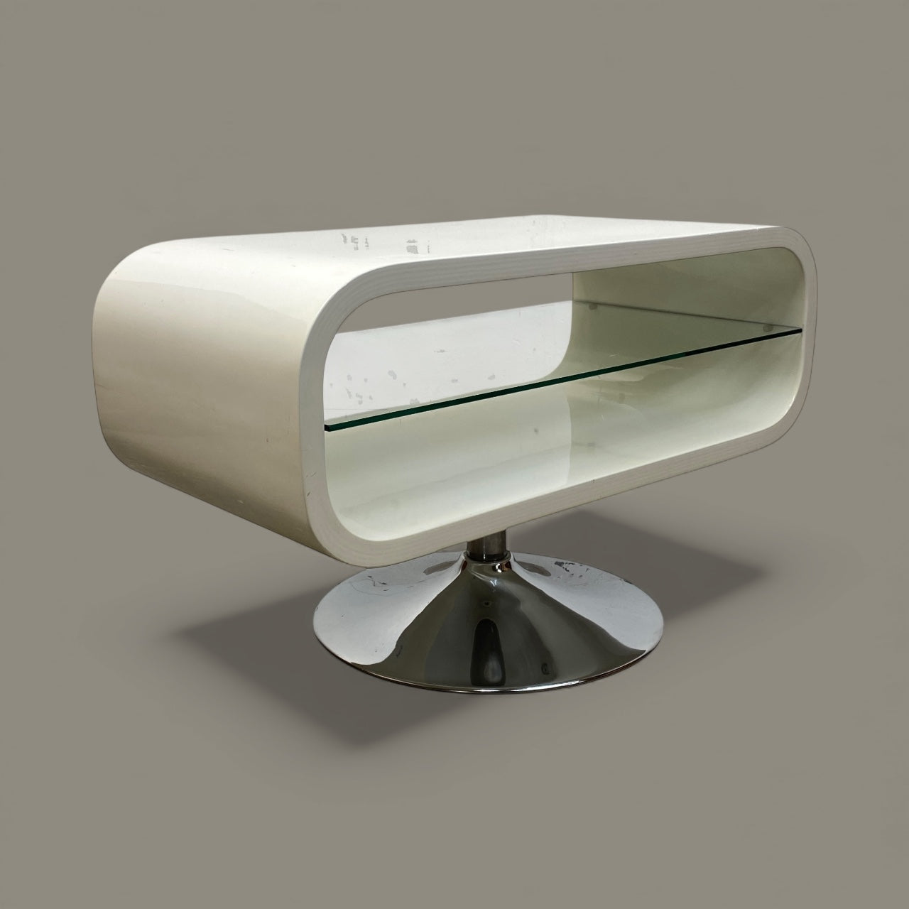 Modern TV with curved design and glass top on a gray background