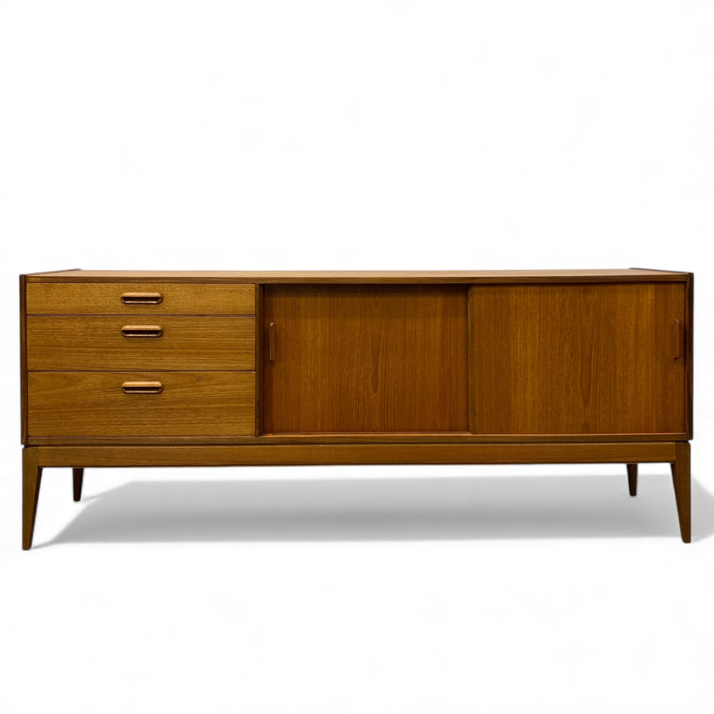 Wooden sideboard with drawers and a door on a white background