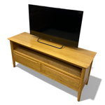 Load image into Gallery viewer, Wooden TV stand with a television on top against a white background
