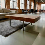 Load image into Gallery viewer, Modern coffee table in a room with large windows and a couch.
