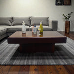 Load image into Gallery viewer, Living room with a gray sectional sofa, wooden coffee table, and decorative items.
