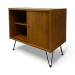 Load image into Gallery viewer, Wooden cabinet with a door and shelves on black legs against a white background
