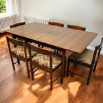 Load image into Gallery viewer, Wooden dining table with four chairs on a wooden floor
