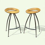 Load image into Gallery viewer, Two wooden stools with black metal legs on a white background
