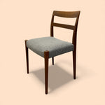 Load image into Gallery viewer, Wooden chair with a textured blue seat on a beige background
