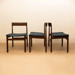 Load image into Gallery viewer, Three wooden chairs with black seats on a beige background
