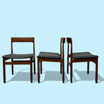 Load image into Gallery viewer, Three wooden chairs with black seats on a light blue background
