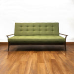 Load image into Gallery viewer, green sofa on a wooden floor
