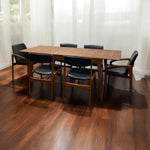 Load image into Gallery viewer, Dining table with chairs in a room with wooden flooring and white curtains.
