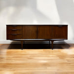 Load image into Gallery viewer, Wooden sideboard against a white wall on a wooden floor
