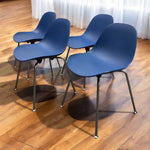 Load image into Gallery viewer, Four blue chairs with metal legs on a wooden floor.
