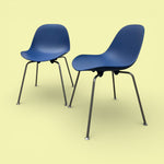Load image into Gallery viewer, Two blue chairs with black legs on a yellow background
