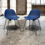 Load image into Gallery viewer, Two blue chairs with black legs on a concrete floor.

