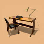 Load image into Gallery viewer, Wooden desk with a vintage typewriter and lamp on a beige background
