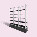 Load image into Gallery viewer, Black shelving unit with glass panels on a pink background
