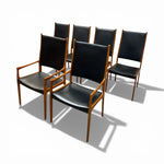 Load image into Gallery viewer, Set of six black chairs with wooden frames on a white background

