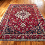 Load image into Gallery viewer, Decorative red and black patterned rug on a wooden floor

