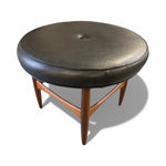 Load image into Gallery viewer, Round stool with black leather seat and wooden legs on a white background
