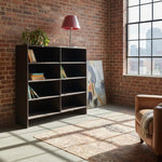 Load image into Gallery viewer, Modern bookshelf against a brick wall with a cityscape view
