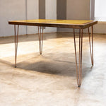 Load image into Gallery viewer, Wooden table with metal legs on a light wooden floor
