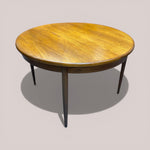 Load image into Gallery viewer, Round wooden table with a beige background
