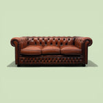 Load image into Gallery viewer, Reddish Brown leather sofa on a light green background
