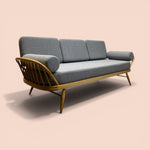 Load image into Gallery viewer, Gray sofa with wooden frame on a beige background
