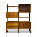 Load image into Gallery viewer, Wooden wall unit with shelves and drawers on a white background
