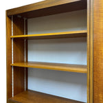 Load image into Gallery viewer, Wooden bookshelf with multiple shelves against a white wall
