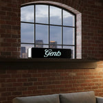 Load image into Gallery viewer, Window with 'Gents' sign on a brick wall, reflecting cityscape
