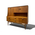 Load image into Gallery viewer, Mid-century modern wooden hutch cabinet with a warm medium-brown wood grain finish, featuring two upper doors, an open shelf, three drawers on the left, and two lower cabinet doors on the right, supported by tapered legs.
