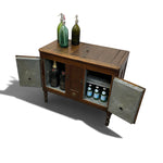 Load image into Gallery viewer, A rustic wooden bar cabinet with two open doors, shown on a plain white background. The cabinet has a medium brown wood finish, turned legs, and weathered gray metal doors.
