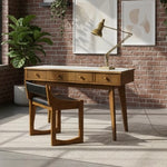 Load image into Gallery viewer, A mid-century modern wooden writing desk with a light-colored stone top and matching chair, styled in a room with a brick wall, potted plant, and brass desk lamp.
