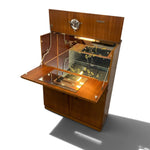 Load image into Gallery viewer, A wooden cabinet display case with a glass-front upper section and an open lower drawer or shelf, shown on a white background with a cast shadow.
