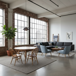 Load image into Gallery viewer, A modern loft-style living room with a dark gray sectional sofa, light blue accent chairs, a round wooden dining table with spindle-back chairs, a large potted fiddle-leaf fig, exposed brick walls, and tall industrial windows.
