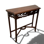 Load image into Gallery viewer, A dark brown wooden console table with ornate carved details under the tabletop and curved legs, shown on a white background with a prominent shadow.
