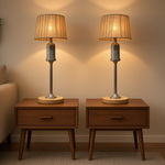 Load image into Gallery viewer, Two matching table lamps with ribbed beige drum shades and brushed metal bases, placed on wooden nightstands against a warm beige wall.
