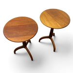 Load image into Gallery viewer, Two round wooden side tables with curved tripod legs, shown on a clean white background.
