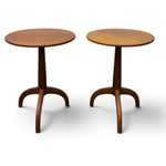 Load image into Gallery viewer, Two round wooden side tables with curved tripod legs, shown on a clean white background.
