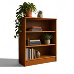 Load image into Gallery viewer, A three-tier wooden bookcase with a warm medium-brown finish, styled with books, potted plants, and a small vase against a plain white background.
