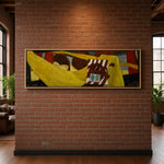 Load image into Gallery viewer, A framed abstract canvas painting with bold yellow, red, brown, and black shapes hangs on a red brick wall in a loft-style room with wood floors and windows.
